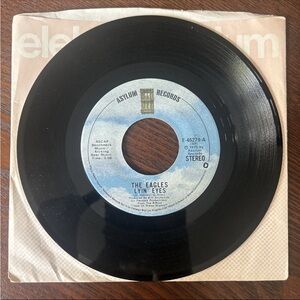The Eagles 7” Vinyl Record- “Lyin’ Eyes” “Too Many Hands”